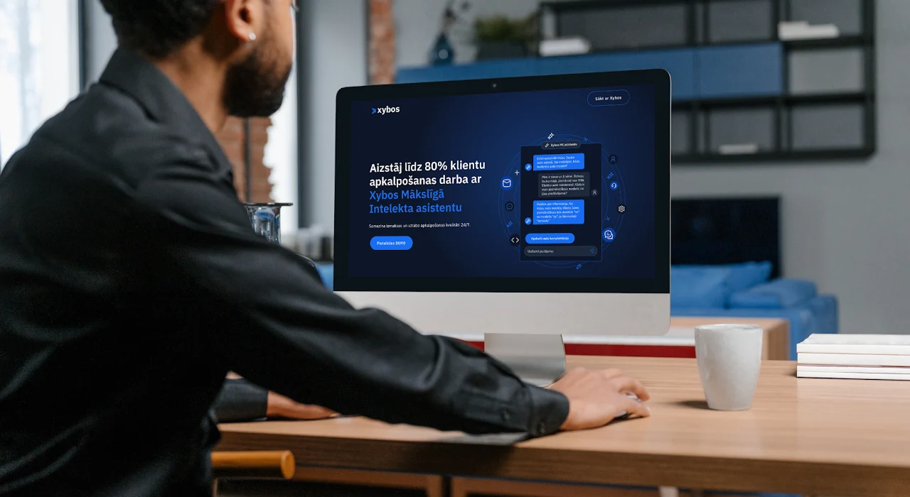 Xybos one-page website hero shown on a desktop in a real workspace
